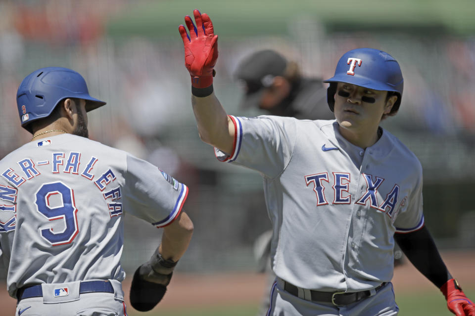 Texas Rangers' Shin-Soo Choo, right, celebrates with Isiah Kiner-Falefa (9) after hitting a two run home run off San Francisco Giants' Jeff Samardzija in the fifth inning of a baseball game Sunday, Aug. 2, 2020, in San Francisco. (AP Photo/Ben Margot)