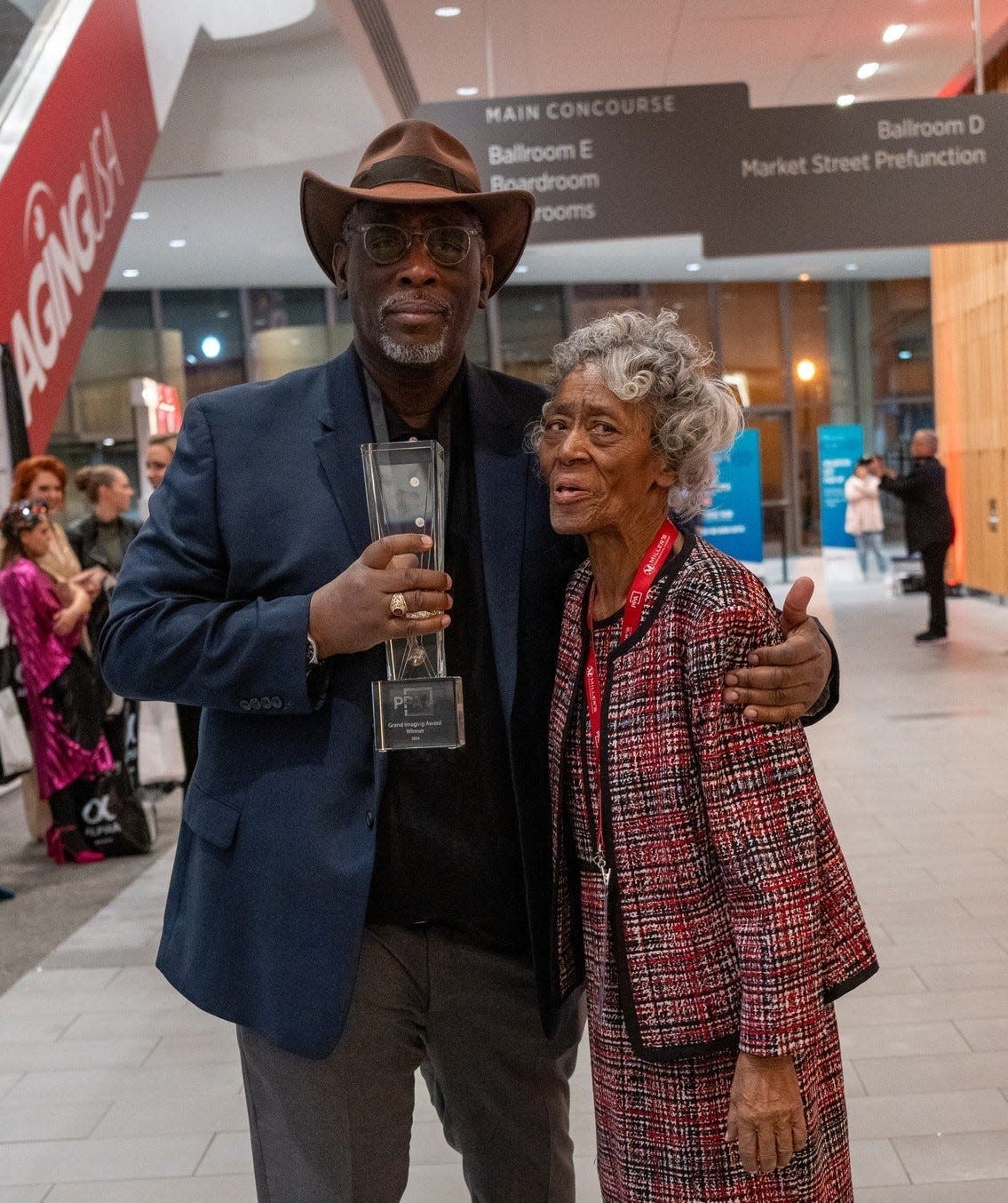 Gary D. Jones strikes a pose with his mom Azzie L. Jones and PPA 2024 Grand Imaging Award trophy. Both are Petersburg, Va. natives who reside in Washington, D.C.