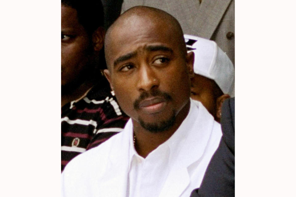 FILE - Rapper Tupac Shakur attends a voter registration event in South Central Los Angeles on Aug. 15, 1996. Shakur's handwritten lyrics from classic songs such as "California Love" and "Dear Momma" along galleries that pay homage to his upbringing and mother are among the artifacts featured in a massive touring museum exhibit. The Shakur Estate announced Tuesday, Nov. 2, 2021, that the "Tupac Shakur. Wake Me When I'm Free" will open on Jan. 21, 2022, in Los Angeles. (AP Photo/Frank Wiese, File)