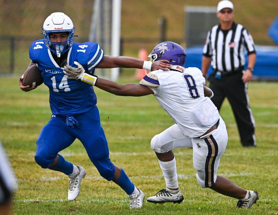 Williamsport's Corry Nelson fends off Smithsburg's Xavier Douge during the Wildcats' Week 2 victory over the Leopards.