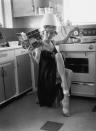 <p>Actress Barbara Roscoe demonstrates her multitasking skills at home in 1963, as she mans the stove while drying her hair. </p>