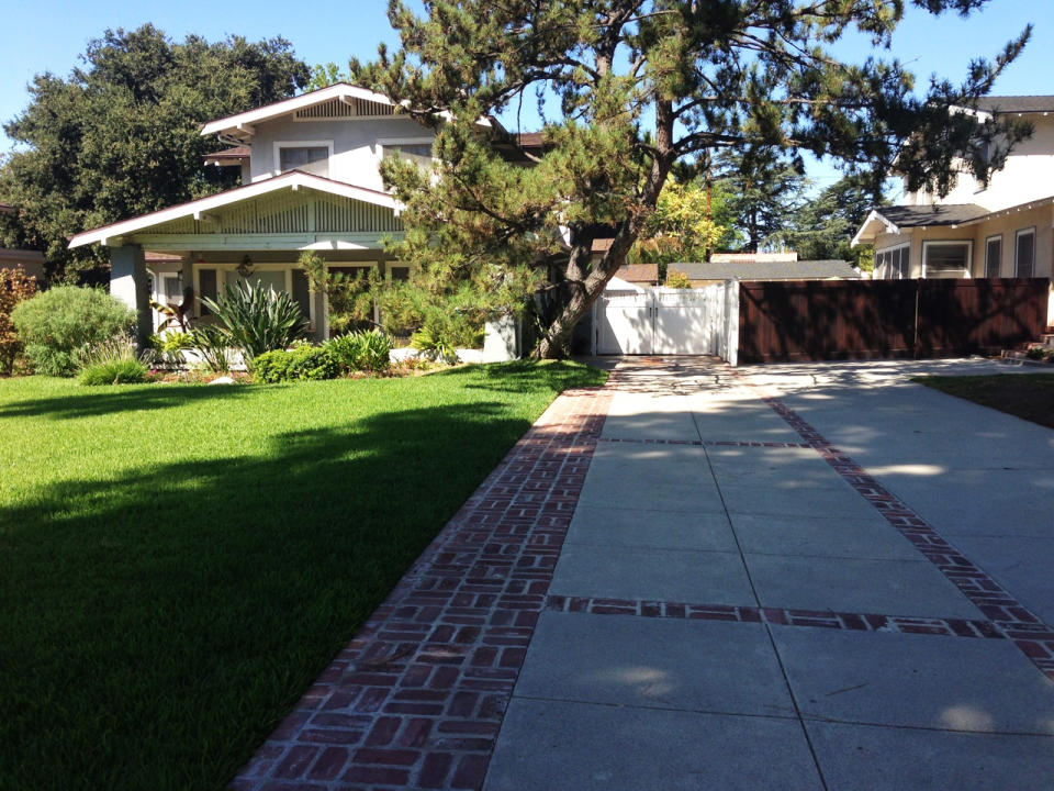 This Sept. 12, 2013 handout photo provided by David Ulick shows a new concrete drive with an antique finish accented with reclaimed red bricks from the 1920s, in Pasadena, Calif. “I wanted this to look like the original driveway, an original, nice driveway, and using used bricks gives it a nice old-fashioned look,” Ulick said. (AP Photo/David Ulick, David Ulick)