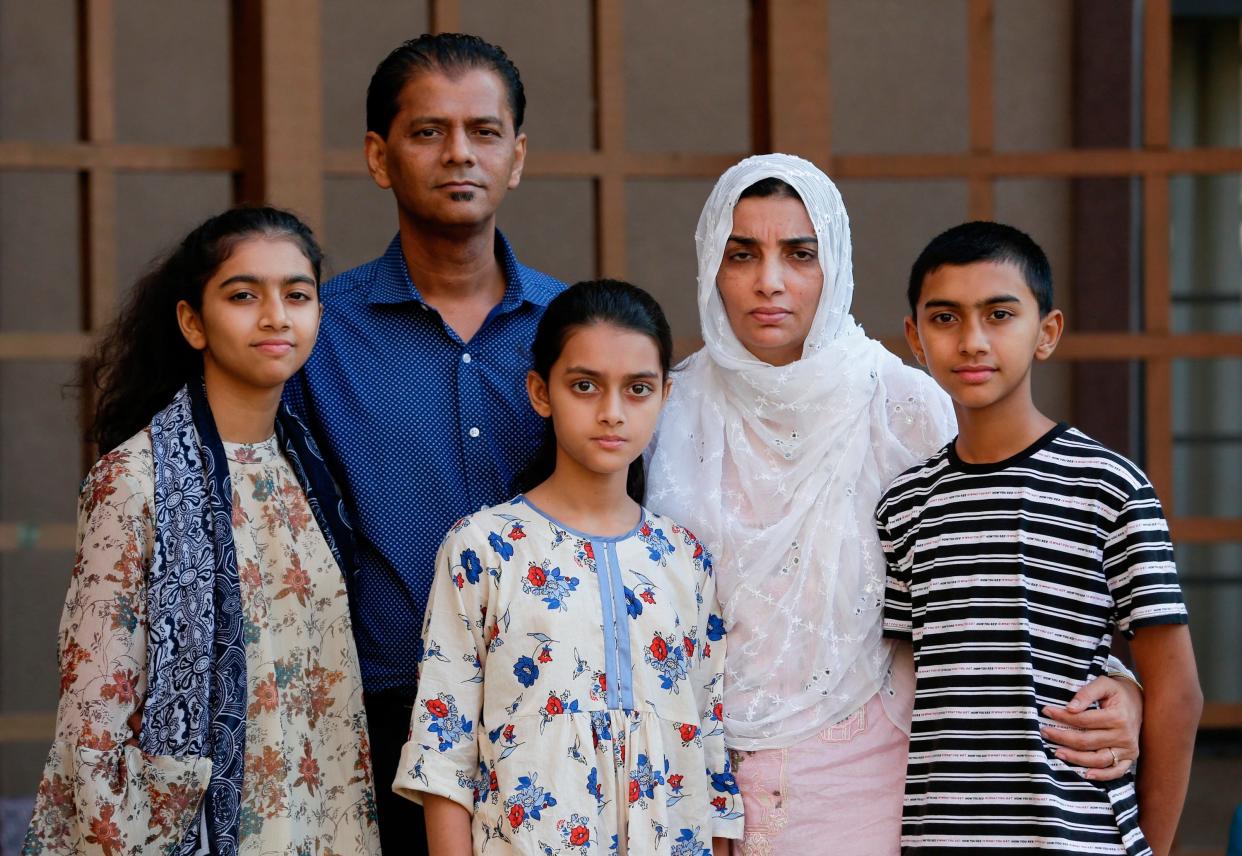 Family members of Santa Fe High School shooting victim Sabika Aziz Sheikh, 17, pose at their home during an interview in Houston, on July 10, 2019. They are, from left, sister Sania Aziz Sheikh, 15; Abdul Aziz, father; sister Soha Aziz Sheikh, 11; Farah Naz, mother, and brother Ali Aziz Sheikh, 14. The families of those killed and injured in a 2018 Texas high school shooting have settled a lawsuit Thursday, Feb. 9, 2023, that they had filed against a Tennessee-based online retailer accused of illegally selling ammunition to the student authorities say fatally shot 10 people on the campus.