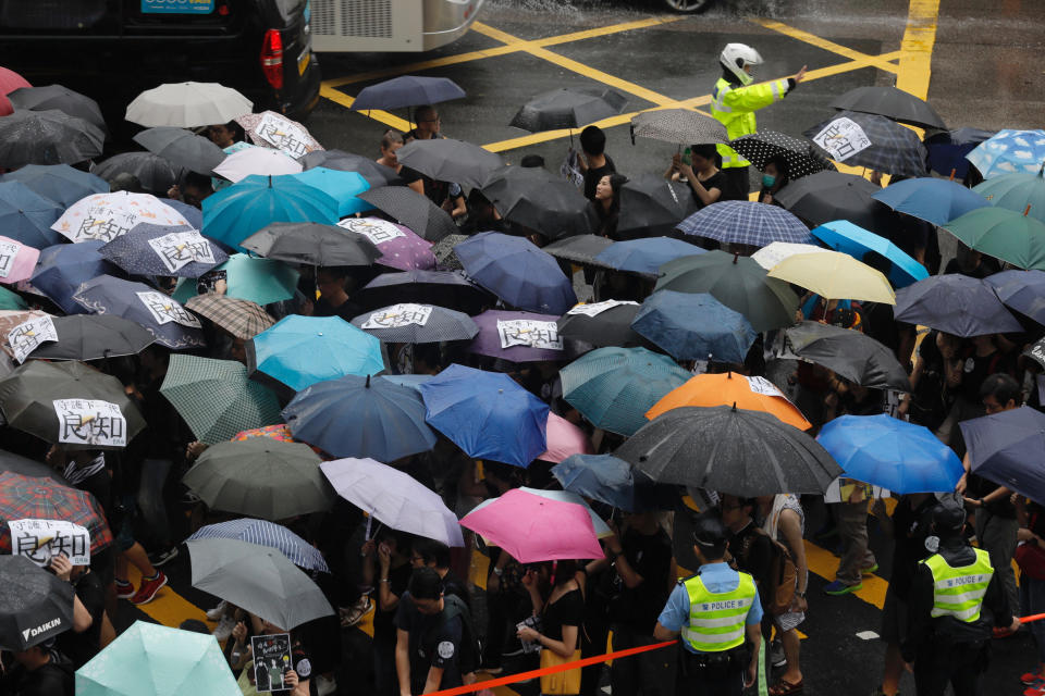 Pro-democracy protesters march organized by teachers in Hong Kong Saturday, Aug. 17, 2019. Members of China's paramilitary People's Armed Police marched and practiced crowd control tactics at a sports complex in Shenzhen across from Hong Kong in what some interpreted as a threat against pro-democracy protesters in the semi-autonomous territory. (AP Photo/Vincent Yu)