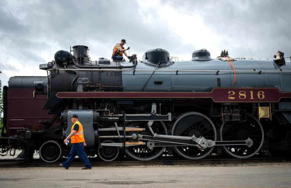 Ben Cummings, top, a locomotive engineer from Lethbridge, Alberta, Canada, works on the Empress 2816, a 1930 steam locomotive, on Thursday, May 16, 2024, at the CPKC rail yard in Kansas City. Canadian Pacific Kansas City (CPKC) is celebrating its’ anniversary, the merger with KC Southern, with the Final Spike Anniversary Steam Tour, which makes a stop at Union Station on Saturday, May 18, 2024.