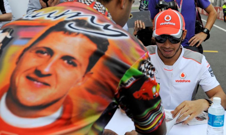 Lewis Hamilton signs during an autograph session with fans at the Buddh circuit on the outskirts of New Delhi in October 2012.