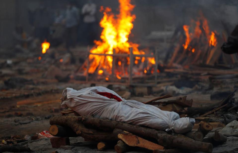 <div class="inline-image__caption"><p>The body of someone who died from COVID-19 lies on a funeral pyre during a mass cremation, at a crematorium in New Delhi, India May 1, 2021. </p></div> <div class="inline-image__credit">REUTERS/Adnan Abidi</div>