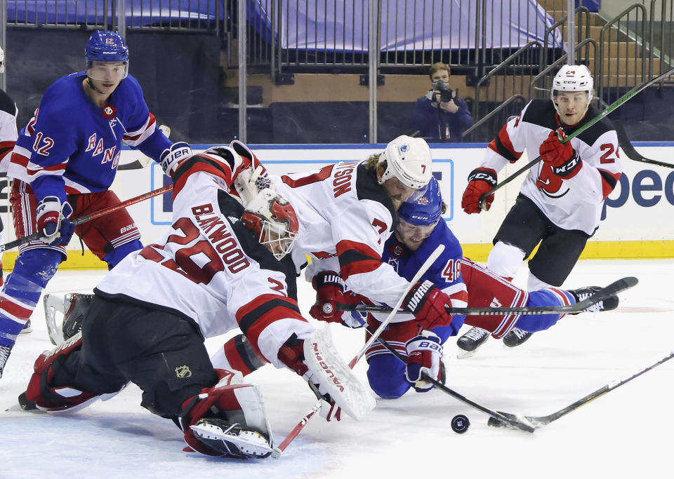 New Jersey Devils' Mackenzie Blackwood (29) and Matt Tennyson defend against New York Rangers' Brendan Lemieux, right, during the second period of an NHL hockey game Tuesday, Jan. 19, 2021, in New York. (Bruce Bennett/Pool Photo via AP)