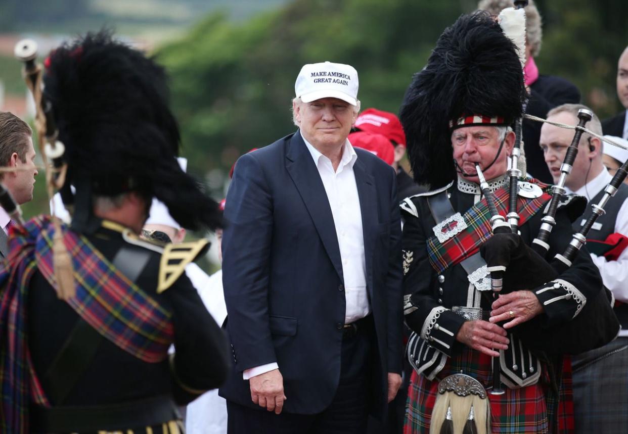 Donald Trump poses with a bagpiper as he arrives at his revamped Trump Turnberry golf course, June 24, 2016, in Turnberry, Scotland. (Photo: Andrew Milligan/PA via AP) 