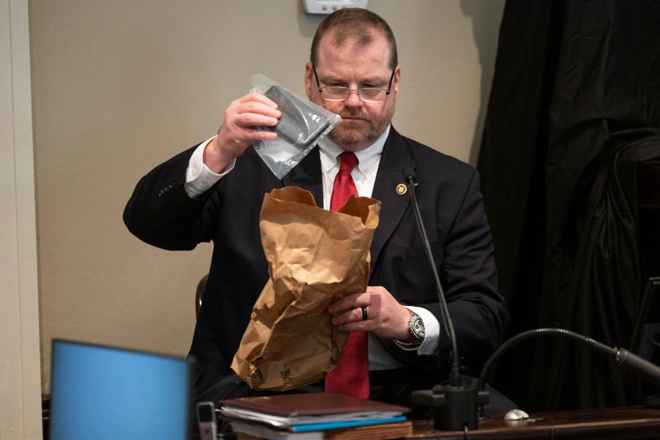 Britt Dove, the SLED agent specialist in computer forensics, returns a cell phone to an evidence bag during Alex Murdaugh's trial for murder at the Colleton County Courthouse in Walterboro, S.C., on Wednesday, Feb. 1, 2023.