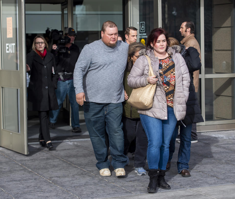 Several members of James Alan Neal's family leave El Paso County's Terry R. Harris Judicial Complex on Thursday, Feb. 21, 2019 in Colorado Springs, Colo. Neal, 72, was arrested Tuesday, Feb. 19, 2019, in Colorado Springs, Colo., and charged with murder with special circumstances in the death of Linda O'Keefe, who was found strangled in 1973, a case that has long shaken the seaside community of Newport Beach, Calif., Orange County District Attorney Todd Spitzer said. (Dougal Brownlie/The Gazette via AP)