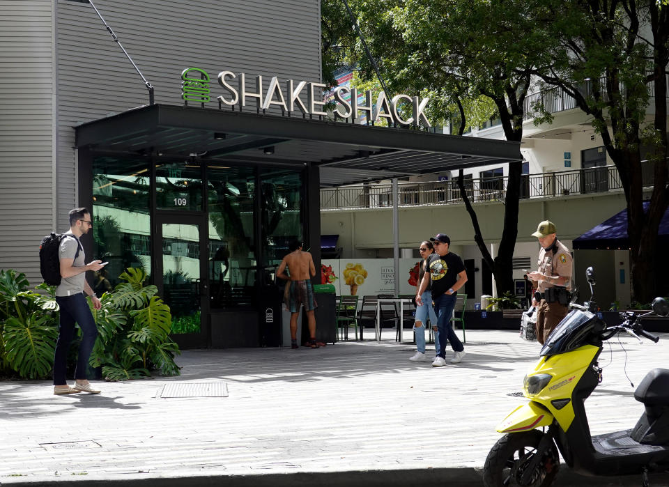 MIAMI, FLORIDA - AUGUST 11: People walk past a Shake Shack restaurant on August 11, 2021 in Miami, Florida.  The Shake Shack company is reported to be planning on raising prices in the last three months of 2021 from 3 percent to 3.5 percent for their food. Consumers in the United States continue to face higher costs as the economy rebounds from the pandemic slowdown. (Photo by Joe Raedle/Getty Images)