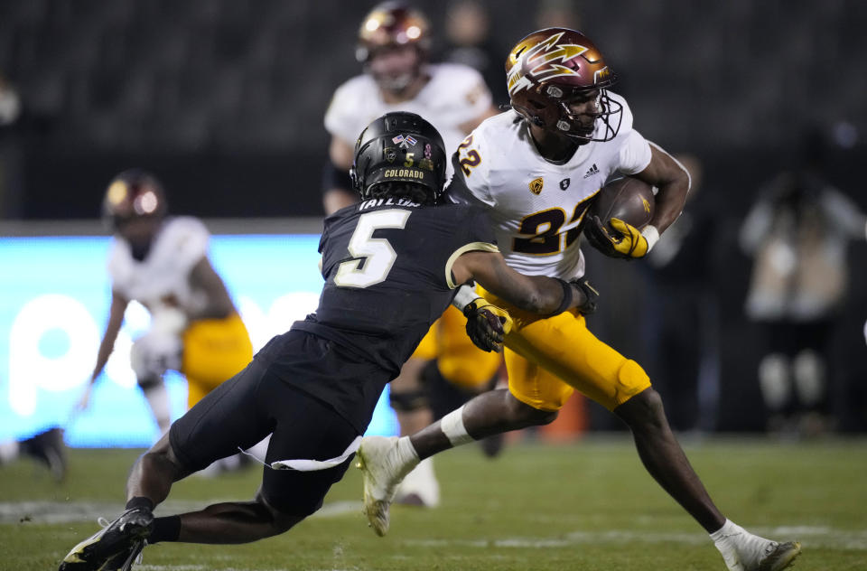 Colorado safety Tyrin Taylor, left, tackles Arizona State wide receiver Bryan Thompson after a short gain in the second half of an NCAA college football game Saturday, Oct. 29, 2022, in Boulder, Colo. (AP Photo/David Zalubowski)