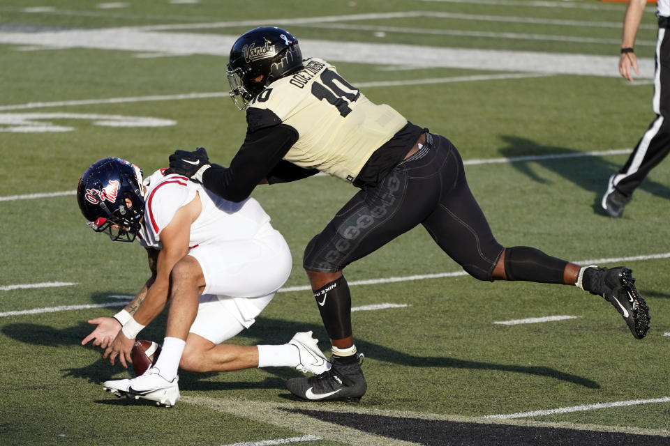 Vanderbilt defensive lineman Dayo Odeyingbo (10) knocks the ball loose from the grip of Mississippi quarterback Matt Corral (2) in the first half of an NCAA college football game Saturday, Oct. 31, 2020, in Nashville, Tenn. (AP Photo/Mark Humphrey)