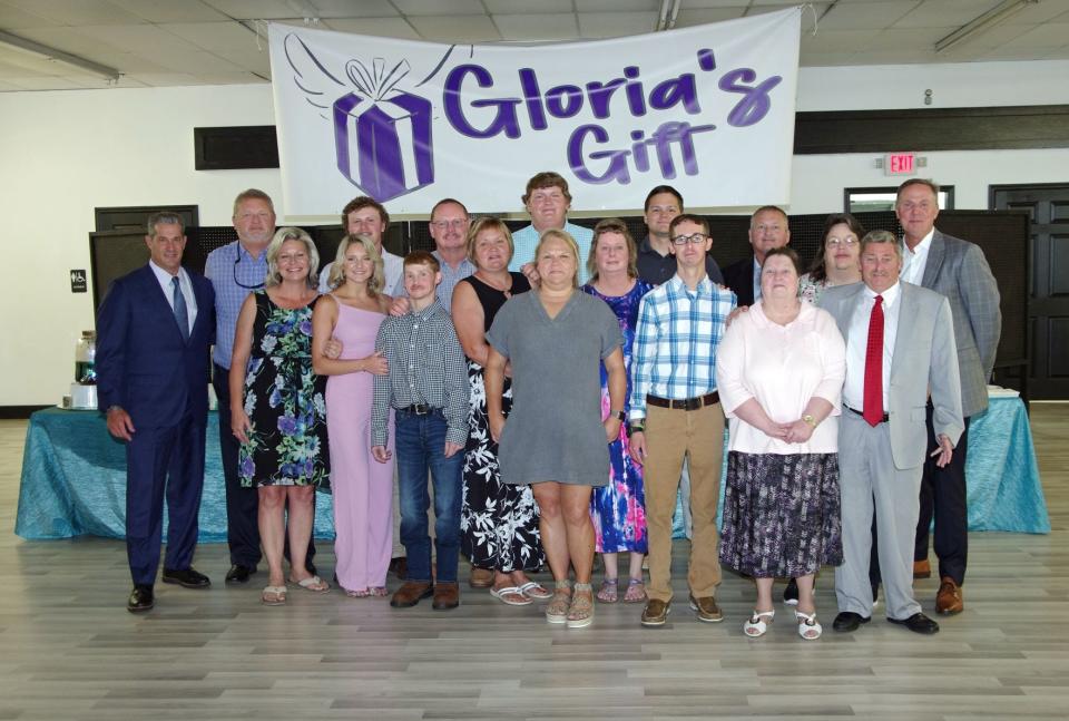 The Satterfield, Harriot and Hadwin families posed for pictures with their attorneys, Eric Bland and Ronnie Richter, at the Stanley Arts Center in Hampton during a June 2022 announcement of a charitable foundation in Gloria Satterfield's memory.