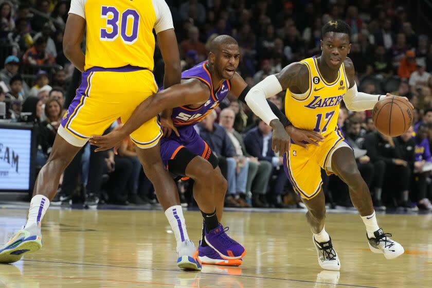 Los Angeles Lakers guard Dennis Schroder (17) drives past Phoenix Suns guard Chris Paul.