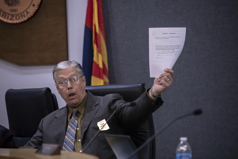 Cochise County District 1 Supervisor Tom Crosby holds a copy of the public meeting's agenda during a discussion over a proposed transfer of election functions and duties to the county recorder, Tuesday, Feb. 14, 2023, in Bisbee, Ariz. Activists are circulating petitions to recall Crosby, one of the two Republicans who voted for the hand count in October. (AP Photo/Alberto Mariani)