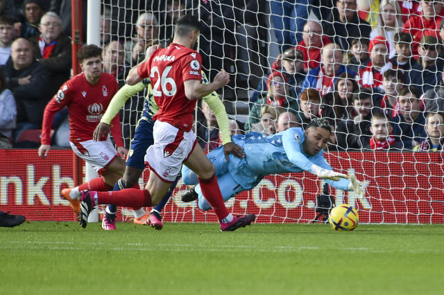 Nottingham Forest's Keylor Navas, right, dives for the ball during the English Premier League soccer match between Nottingham Forest and Leeds United at City Ground stadium in Nottingham, England, Sunday, Feb. 5, 2023. (AP Photo/Rui Vieira)