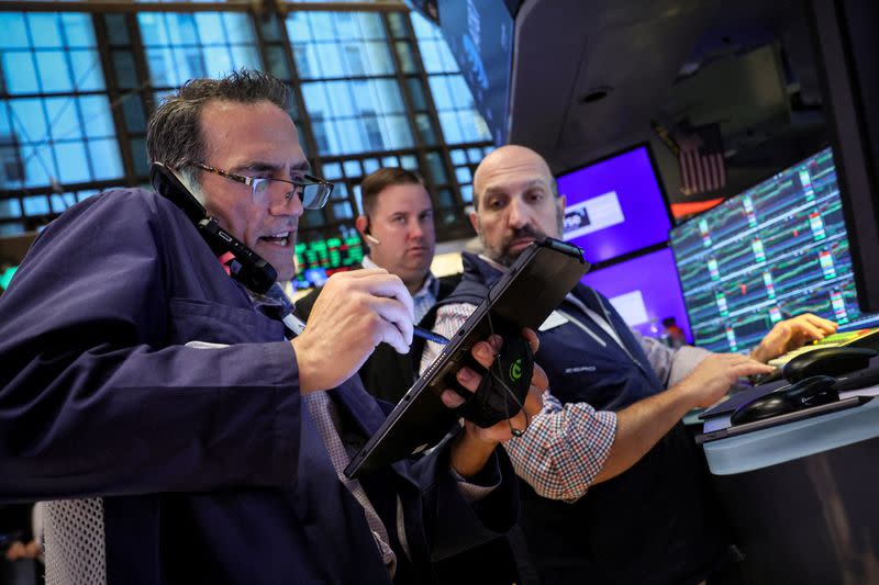 Traders work on the floor of the NYSE in New York