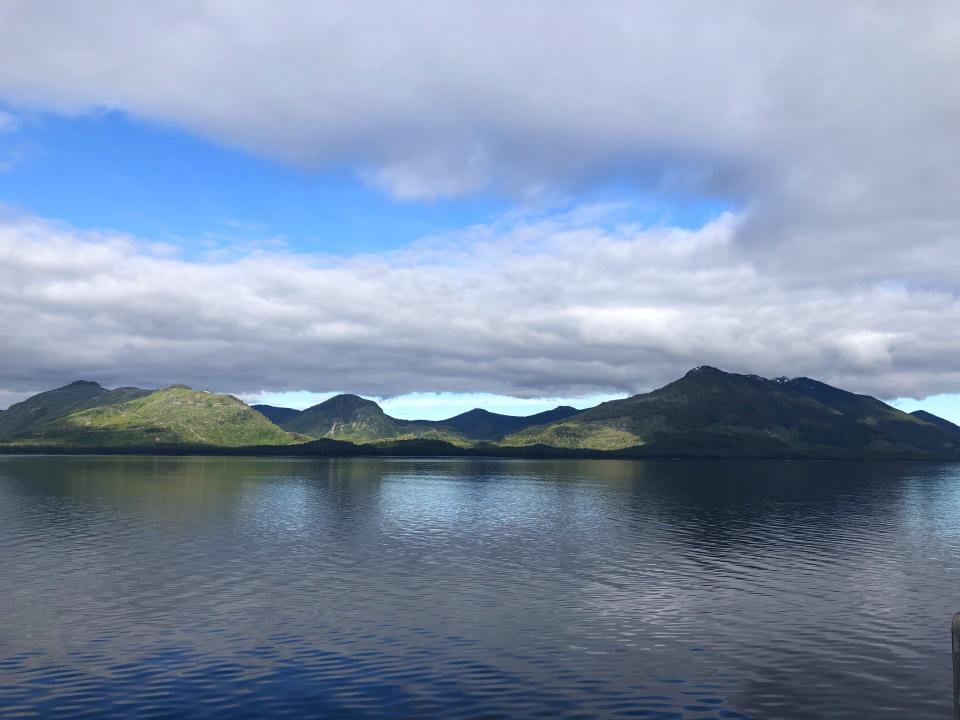 The coastline of archipelago islands in Alaska with low clouds.