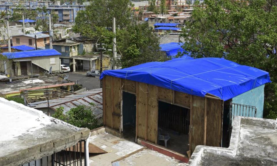 Fema tarps cover homes in San Juan. Fema said it has provided 65,000 tarps but many are still without a roof over their head.