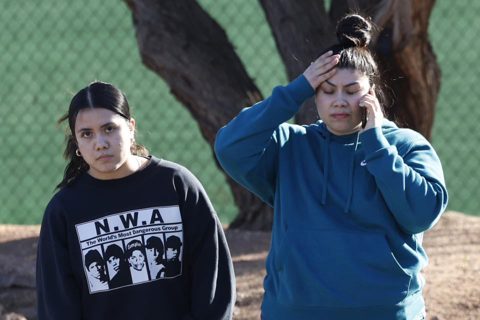 Two women react after a shooting on the University of Nevada, Las Vegas, campus on Wednesday, Dec. 6, 2023, in Las Vegas. (Bizuayehu Tesfaye/Las Vegas Review-Journal via AP)