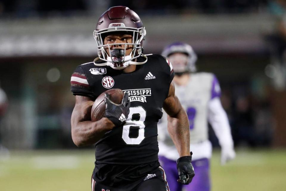 Mississippi State running back Kylin Hill (8) runs past Abilene Christian players on his way to an 88-yard touchdown pass reception during the first half of an NCAA college football game, Saturday, Nov. 23, 2019, in Starkville, Miss. (AP Photo/Rogelio V. Solis)