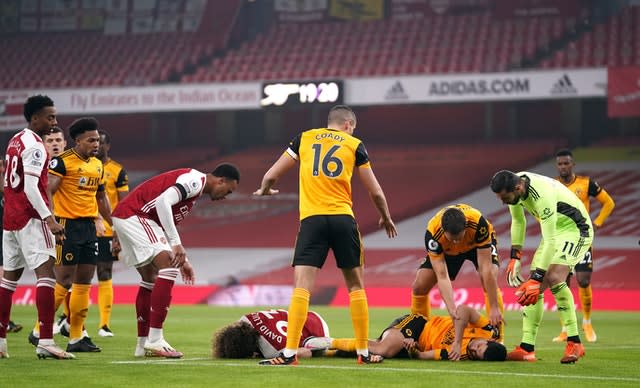 Players show concern after a serious clash of heads between Wolves' Raul Jimenez and David Luiz of Arsenal