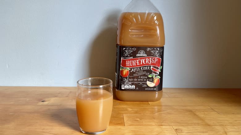 Cider in glass cup with bottle of Nature Nectar cider