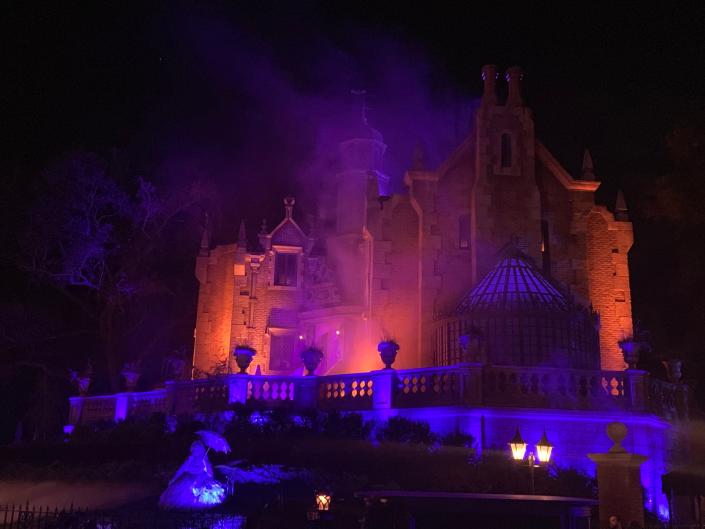 disney world haunted mansion lit up at night
