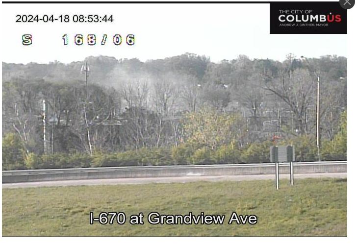 A I-670 traffic camera at Grandview Ave., pointed south toward McKinley Ave shows smoke rising from a truck hazmat fire.
