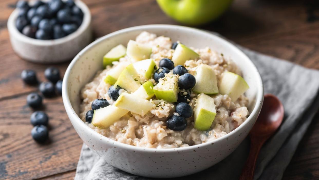 oatmeal porridge with green apple and blueberries