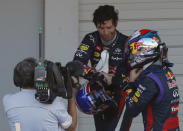 Second-placed Red Bull Formula One driver Mark Webber of Australia shakes hands with Red Bull Formula One driver Sebastian Vettel (R) of Germany after Vettel won the Japanese F1 Grand Prix at the Suzuka circuit October 13, 2013. REUTERS/Toru Hanai (JAPAN - Tags: SPORT MOTORSPORT F1)