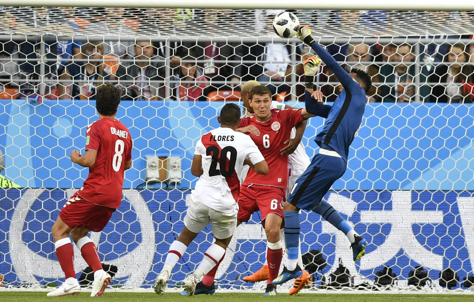 <p>Standing tall: Peru goalkeeper Pedro Gallese punches the ball clear under pressure. (AP) </p>