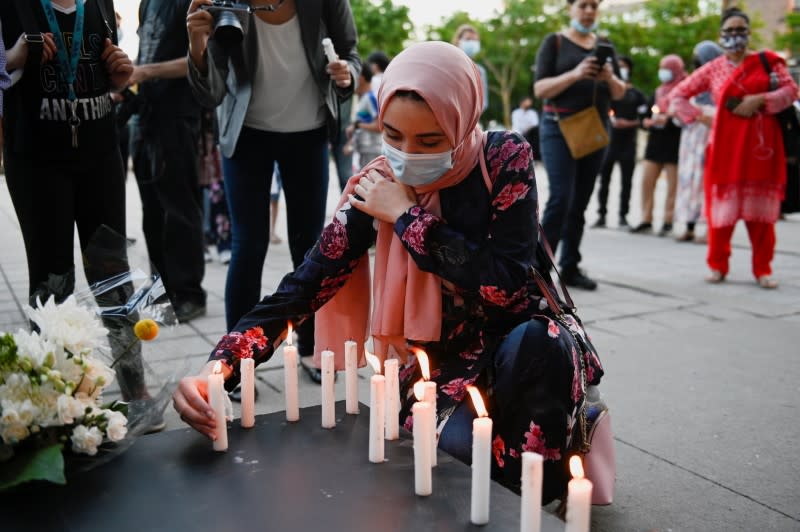 People attend a vigil in memory of a Muslim family in Montreal