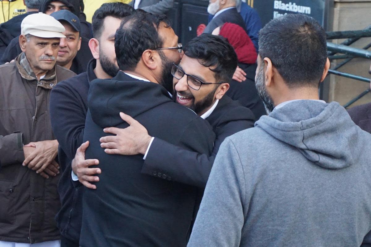 Independent candidate Adnan Hussain was greeted by friends, family and supporters outside King George’s Hall in Blackburn <i>(Image: Nq)</i>