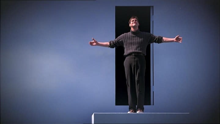 Jim Carrey as Truman Burbank spreading his arms and looking up in The Truman Show.