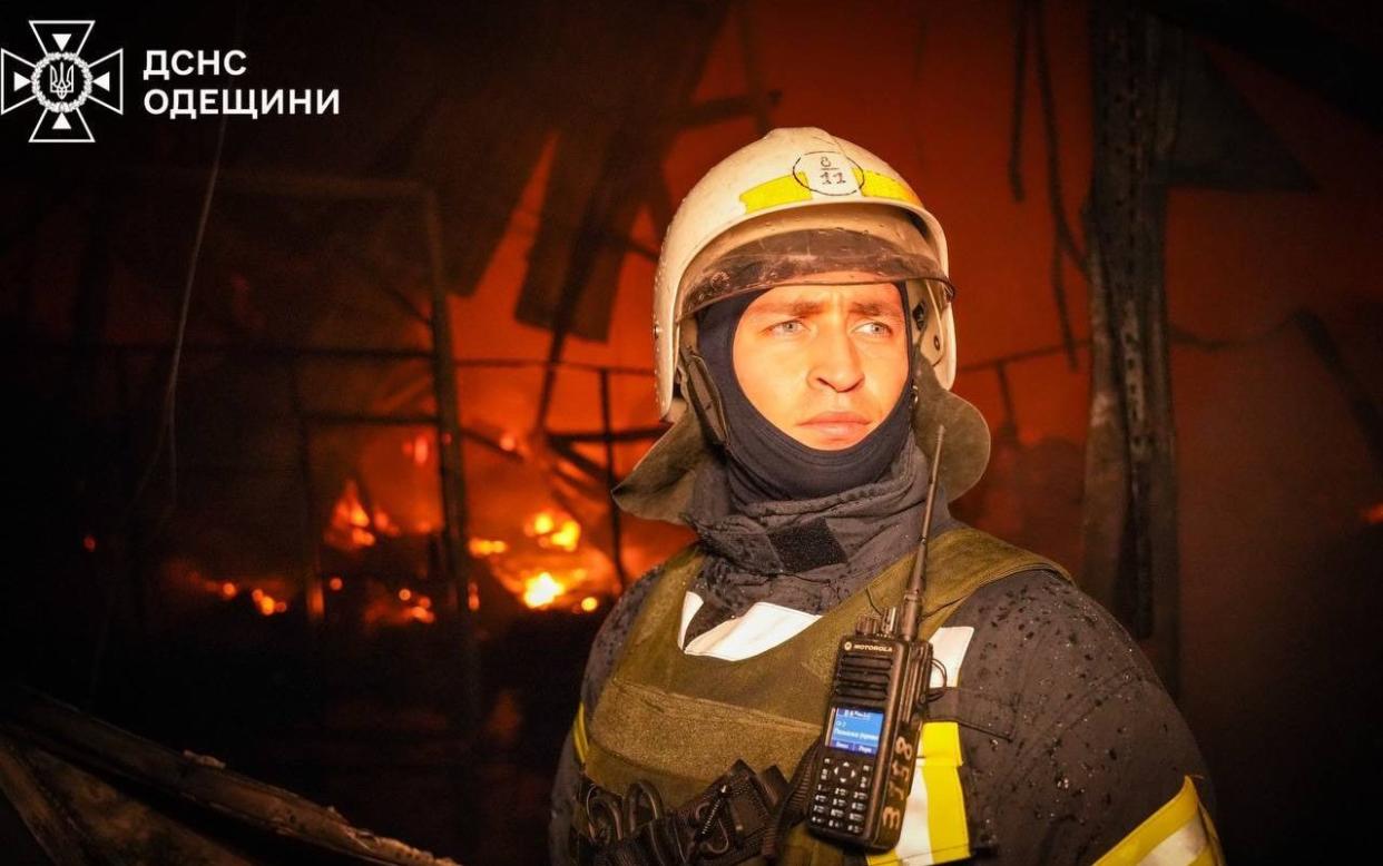 Firefighters try to extinguish a large-scale fire broke out in the area after a Russian missile strike