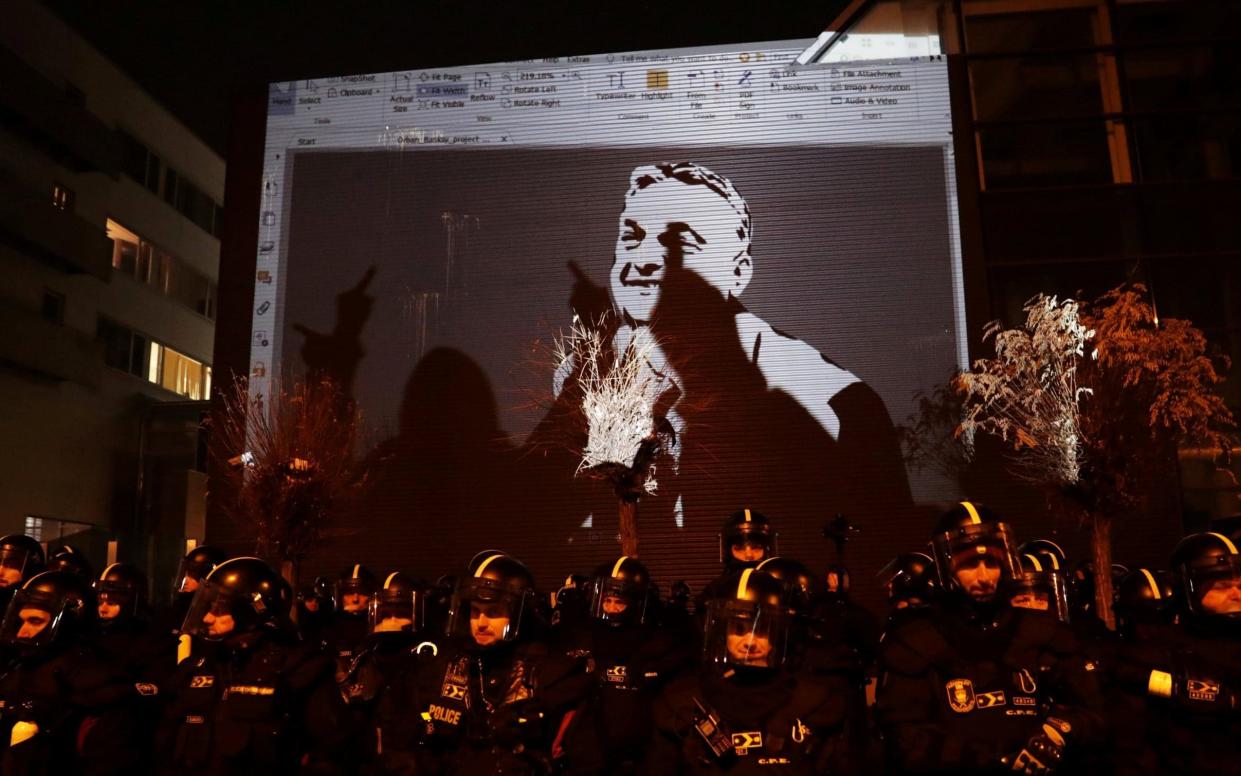 A drawing depicting Hungarian President Viktor Orban is projected on the wall of the TV building during a protest - REUTERS