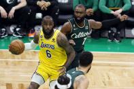 Los Angeles Lakers' LeBron James (6) drives for the basket in front of Boston Celtics' Jaylen Brown (7) during the first half of an NBA basketball game, Saturday, Jan. 28, 2023, in Boston. (AP Photo/Michael Dwyer)