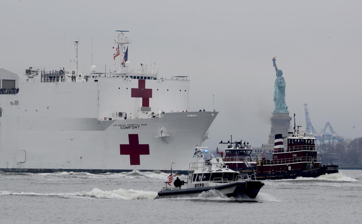 The U.S. Navy Hospital Ship Comfort makes its way past the Statue of Liberty as it sails into New York City March 30, 2020 to aid in the city's battle with the coronavirus. The ship will provide 1000 hospital beds to make room in city hospitals for COVID-19 patients.