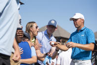 Jordan Spieth hands golf balls to fans after completing the third round of the AT&T Byron Nelson golf tournament in McKinney, Texas, on Saturday, May 14, 2022. (AP Photo/Emil Lippe)
