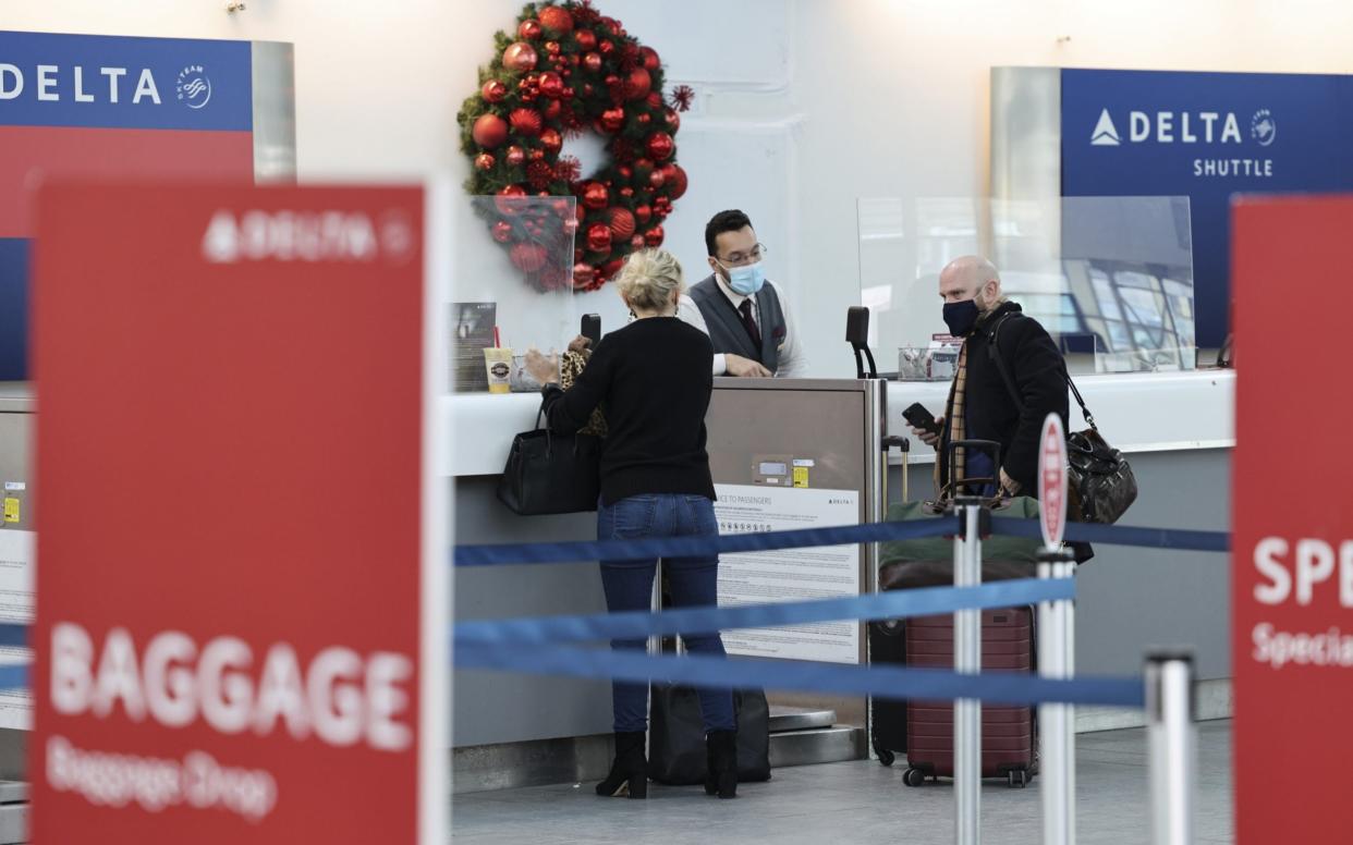 People wearing protective masks check in for a Delta Air Lines Inc. flight at LaGuardia Airport (LGA) in New York, U.S - Angus Mordant /Bloomberg 