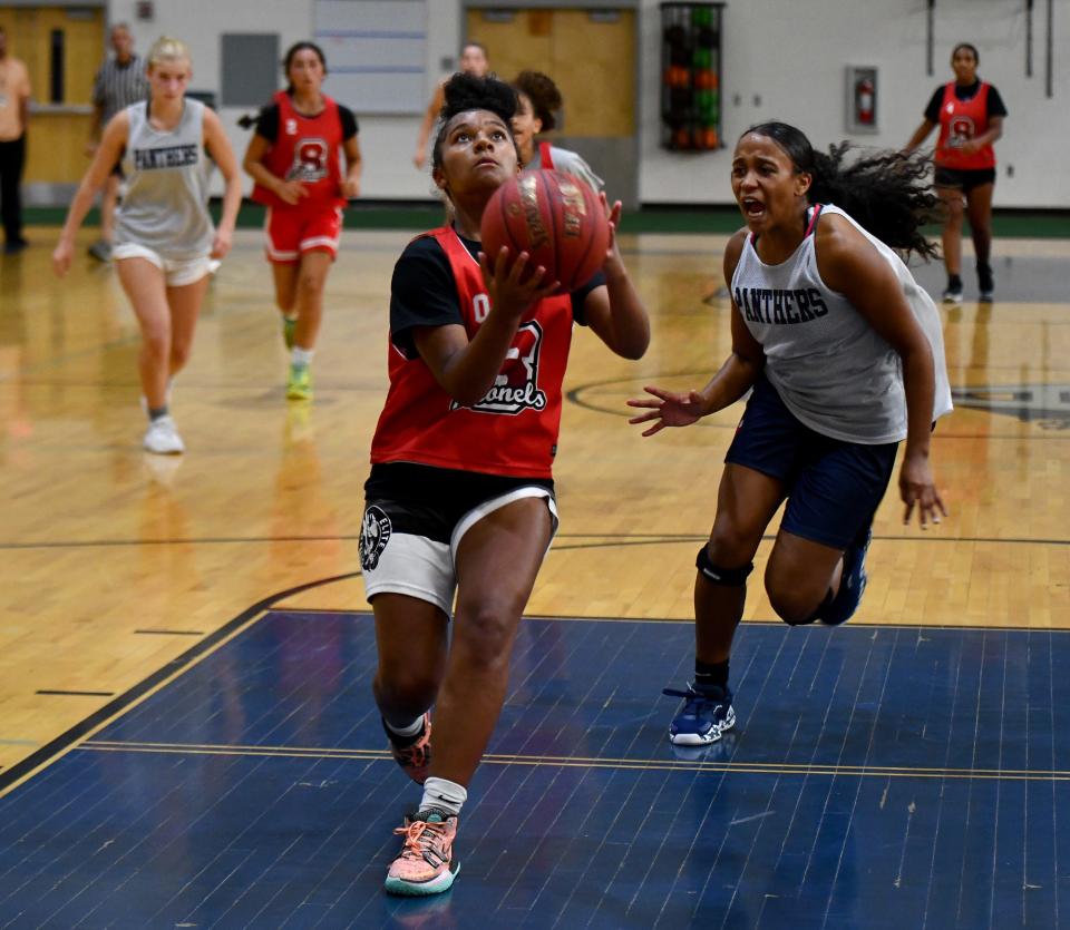 South's Ava MacCollom goes up for a shot past Quabbin's Mia Ducos during Tuesday's championship game of the Auburn Summer League.