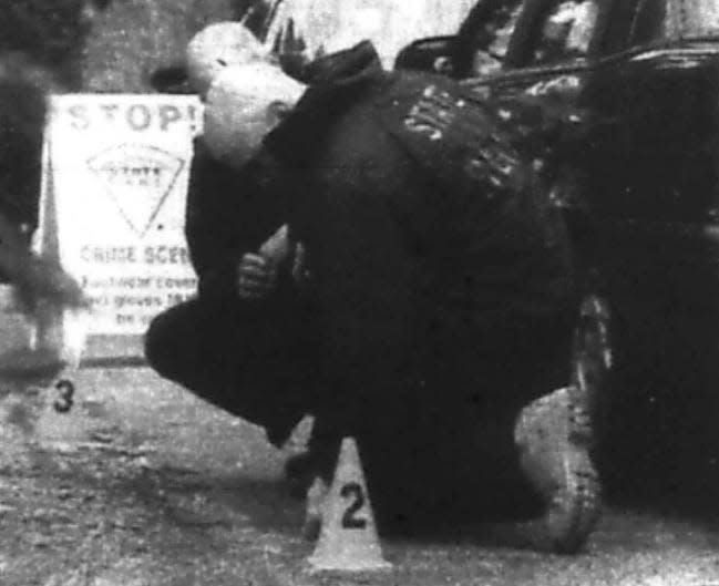 State police examine tire tracks on the lawn of the Acushnet Avenue home where Rose Marie Moniz was murdered in 2001.