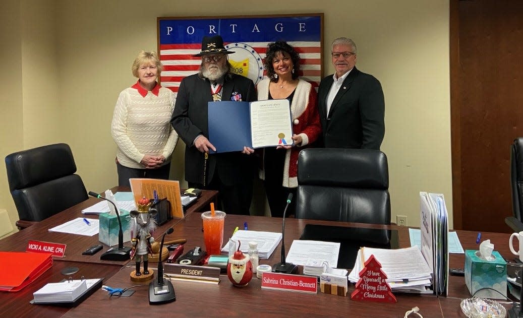 Portage County Commissioners recently recognized Robert Towles, a Vietnam veteran who went on to use his military knowledge to serve his fellow veterans. From left are Commissioner Vicki Kline, Towles, Commissioner Sabrina Christian-Bennett and Commissioner Tony Badalamenti.