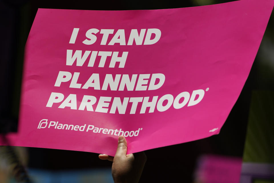 FILE - An abortion-rights supporter waves a Planned Parenthood poster during a rally in Smith Park in Jackson, Miss., June 17, 2022. Planned Parenthood, the nation's leading reproductive health care provider and abortion rights advocacy organization, plans to spend a record $50 million ahead of November's midterm elections, pouring money into contests where access to abortion will be on the ballot. (AP Photo/Rogelio V. Solis)