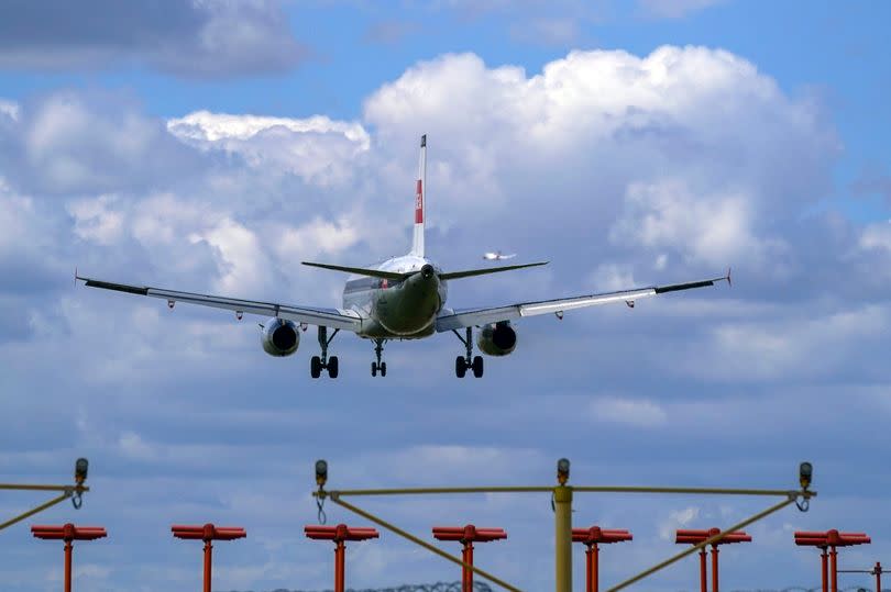 A plane lands on the southern runway at London Heathrow Airport