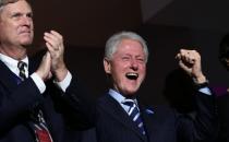 Former US president Bill Clinton (R) cheers as former New York City mayor Michael Bloomberg addresses the Democratic convention in Philadelphia, Pennsylvania