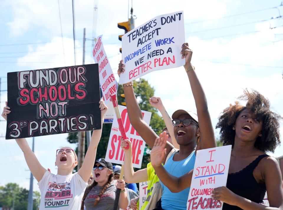 Chloe Heins, left, a ninth grade English teacher at Eastmoor Academy, and senior Eastmoor students Lailah Moorman, 17, center, and Zahni Jackson, 15, right, as Columbus Education Association members picketed at Africentric Early College on Monday afternoon.